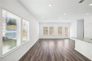 Unfurnished living room featuring a wealth of natu