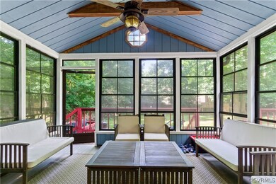 Sunroom with ceiling fan, vaulted ceiling, and a wealth of natural light