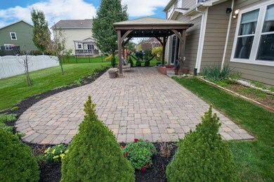 Brick pavers compliment the landscaping in back.