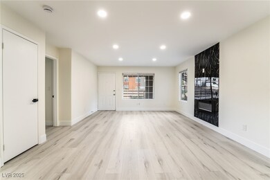 Unfurnished living room with recessed lighting, ba