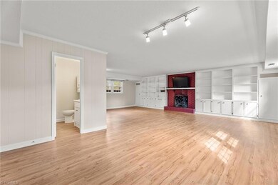 Basement with built in shelves and gas log fireplace