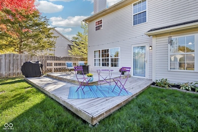 Large deck area with plenty of room for seating that overlooks teh fenced backyard offering amazing sunset views and outdoor firepit, perfect for Smores this Fall!