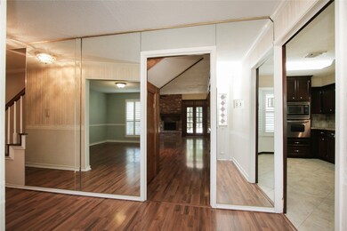 This alternate view from the entry offers glimpses into the family room and kitchen.