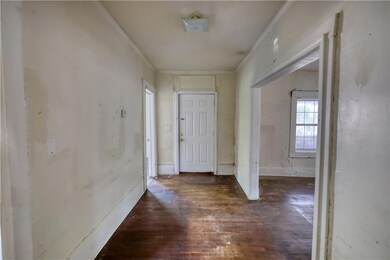 Hallway with hardwood / wood-style flooring and or