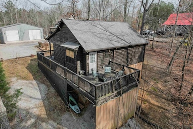 Exterior space featuring a garage and a wooden dec