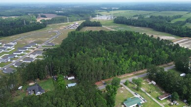 Aerial view of property and surrounding area featuring a heavily wooded area