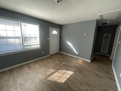 Foyer entrance with dark hardwood / wood-style flo