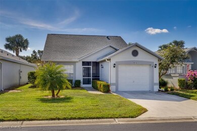 Ranch-style house featuring a garage and a front y