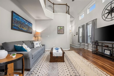 Living area with a high ceiling, wood finished fl