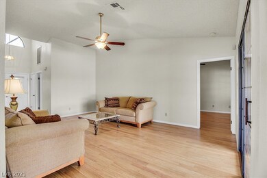 Living room with ceiling fan & light overlooks bac
