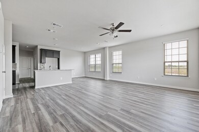Unfurnished living room with wood-type flooring, sink, and ceiling fan