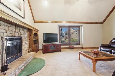 Generous Great Room with lodge-style stone hearth 