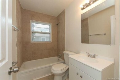 Fully renovated bathroom with new tile.