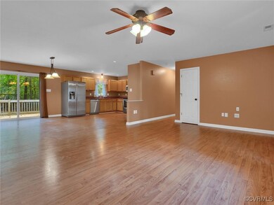 Unfurnished living room with ceiling fan and light hardwood / wood-style floors