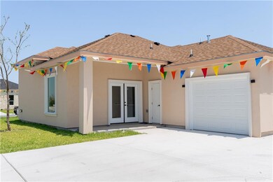 View of front of property with a garage and french doors