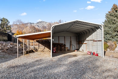 View of parking with a mountain view, a detached carport, and driveway
