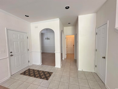 Entrance foyer with baseboards, arched walkways, l