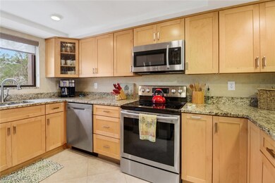 Kitchen with sink, light stone counters, light bro