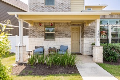Doorway to property with stone siding and brick s