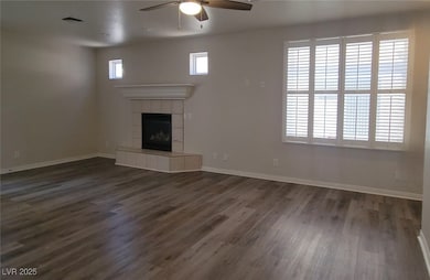 Unfurnished living room featuring a ceiling fan, d