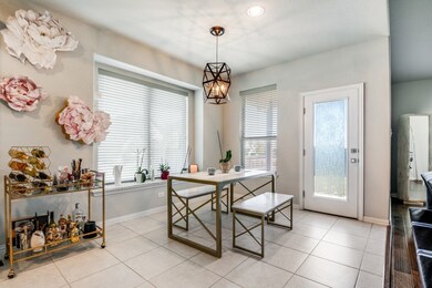 Dining room with plenty of natural light, light tile patterned floors, recessed lighting, and a chandelier