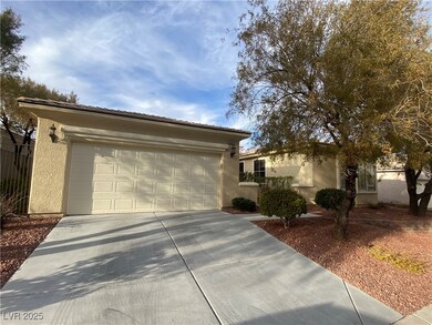 Ranch-style home with concrete driveway, a tiled r