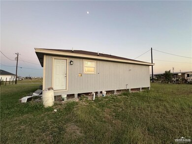 Property exterior at dusk with a lawn