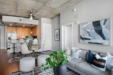 Living area with a ceiling fan and dark wood-styl