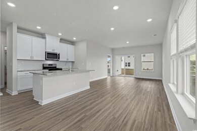 Kitchen featuring light stone counters, appliances