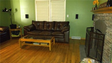 Family room has hardwood floors and a large wood-b