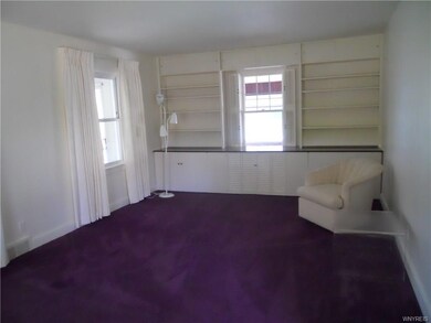Living room with built-in bookshelves & cabinets