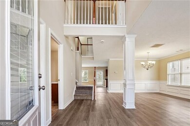 Entryway with wood finished floors, visible vents,
