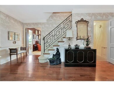 Spacious foyer features new wood floors.