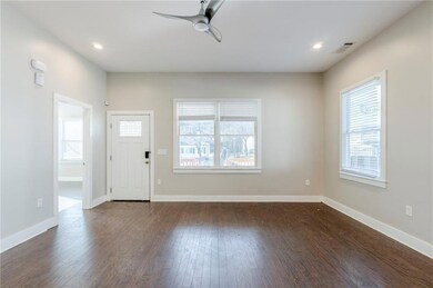 Entryway with dark wood-style floors, recessed lig