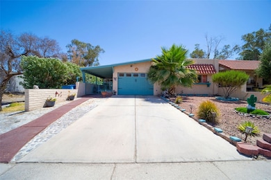 View of front of house with driveway, a carport, f