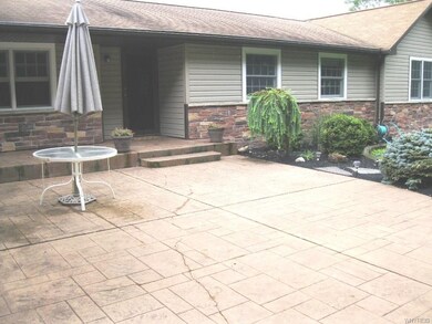 Stamped concrete patio leads to front entry.