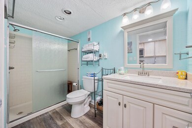 Full bath featuring a textured ceiling, wood finis
