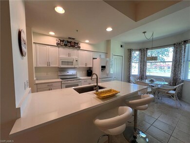 Kitchen with white Shaker cabinetry, sink, a kitch
