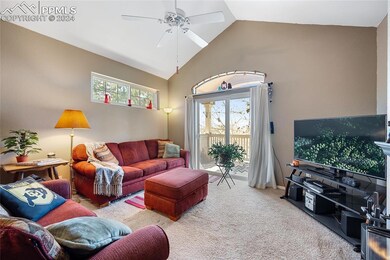 Living room featuring carpet flooring, ceiling fan