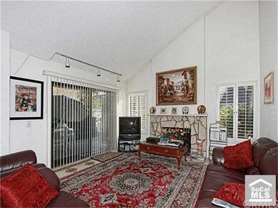 Large living room with vaulted ceilings & wood bur