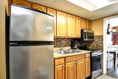 Kitchen with a paneled ceiling, stainless steel ap