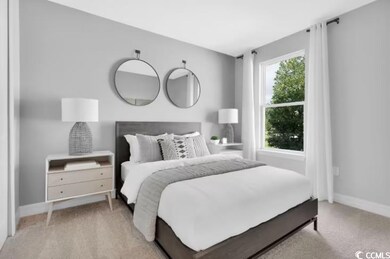 Bedroom with baseboards and light carpet