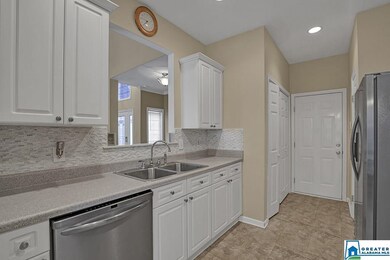 Stainless appliances, crisp white cabinets.