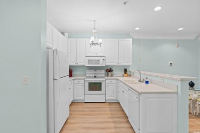 Kitchen featuring white cabinetry, white appliance
