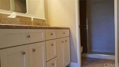 Master bathroom has custom cabinetry, recessed lig