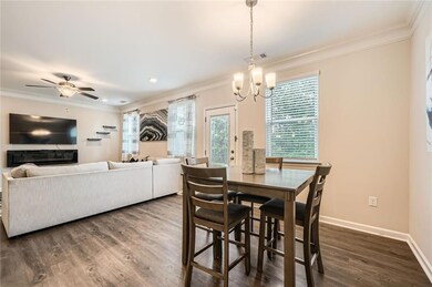 Dining area with ornamental molding, dark wood-typ