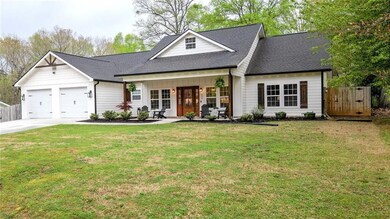 View of front of home with a front yard, concrete 
