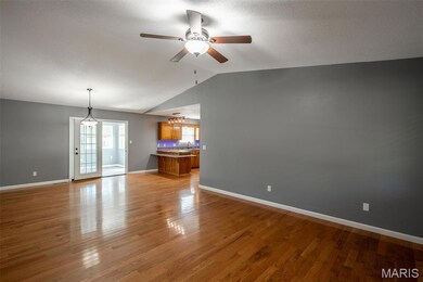Unfurnished living room with light wood-type flooring, a ceiling fan, lofted ceiling, and a textured ceiling