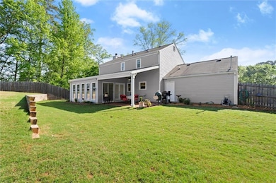 Rear view of property featuring a chimney, a patio