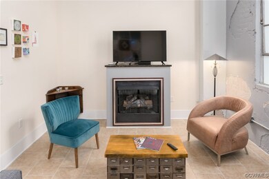 Tiled living room featuring a fireplace and TV